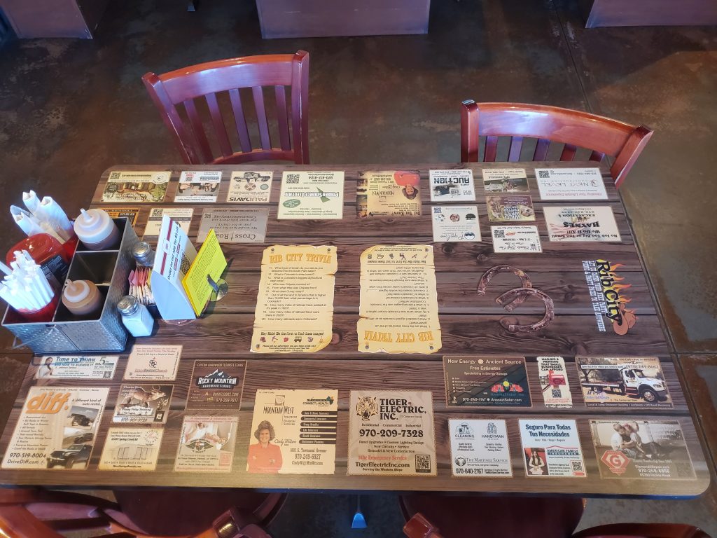 Current table at Rib City Montrose showing the tabletop adverising.